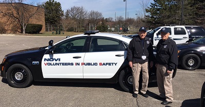 VIPS Volunteers with a Patrol Car