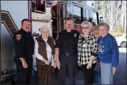 Novi Firefighters and Senior women standing next to a fire truck