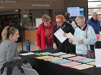 Adults Looking at Travel Flyers